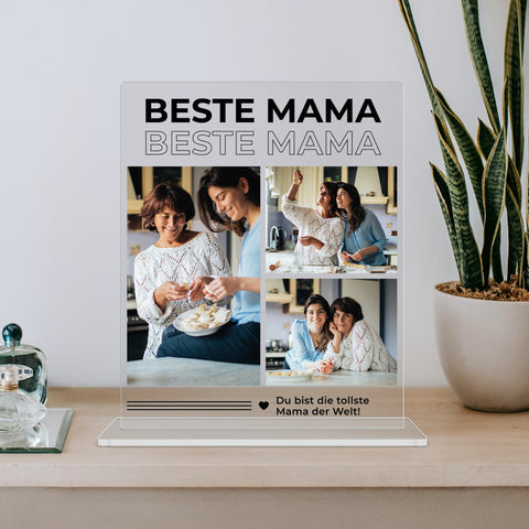 mumaboard Beste Mama Fotocollage aus Acrylglas mit drei Fotos und personalisiertem Spruch „Du bist die tollste Mama der Welt" neben einer Bogenhanf-Pflanze